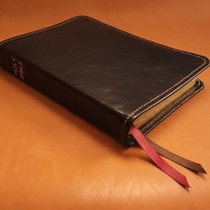 Black sheepskin leather Thinline Bible with honey brown perimeter stitching and two ribbons