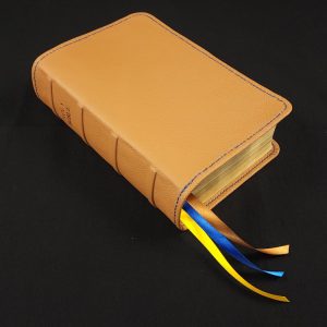 Saddle tan cowhide leather Thinline Bible with navy blue perimeter stitching and three ribbons