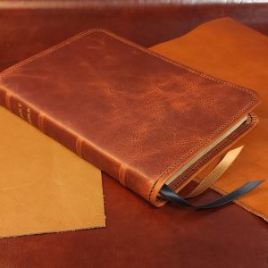 Distressed tan cowhide Thinline Bible with black sheepskin liner and two ribbons