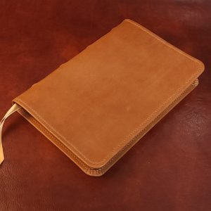 Tan sheepskin Thinline Bible with brown sheepskin liner and two ribbons